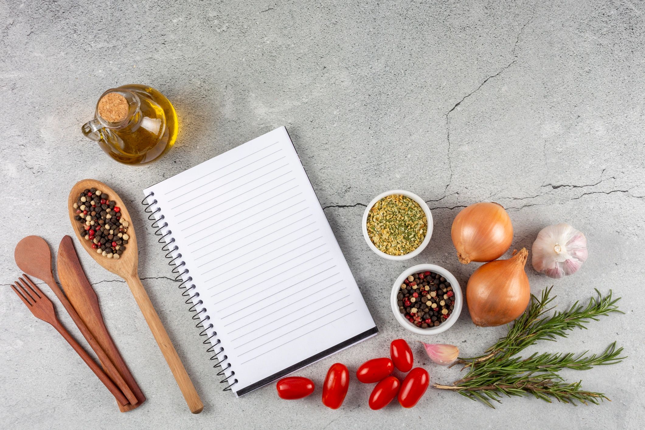 Cookbook with ingredients on the table.